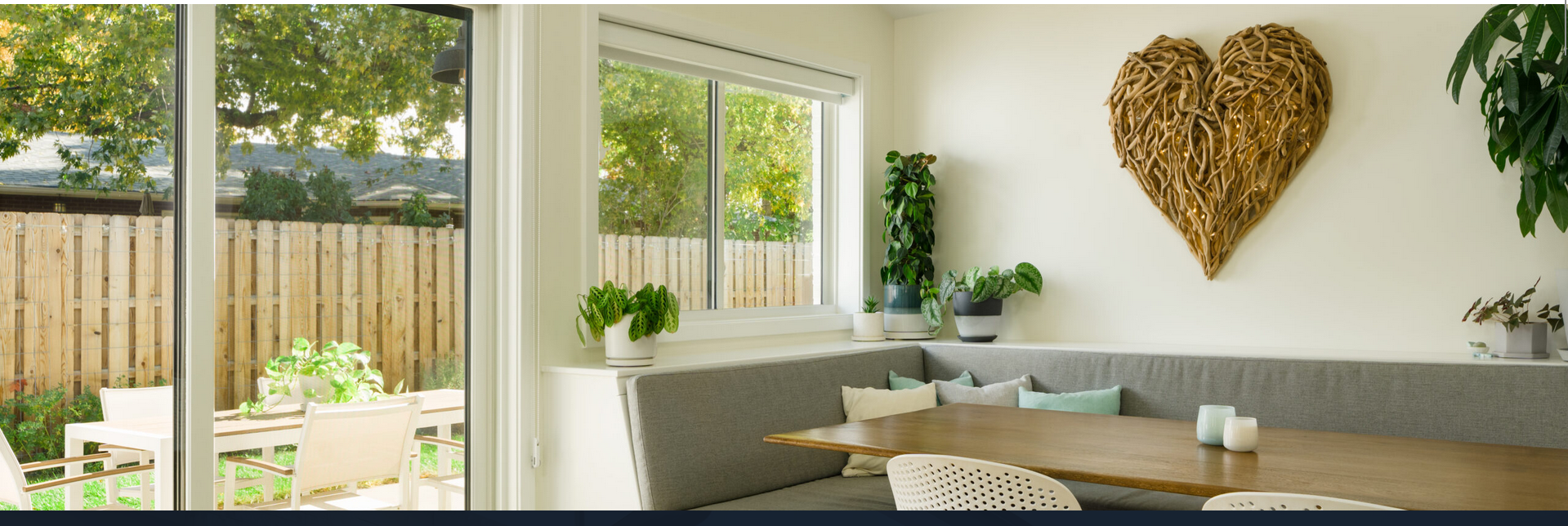 Bright dining nook with heart wall art
